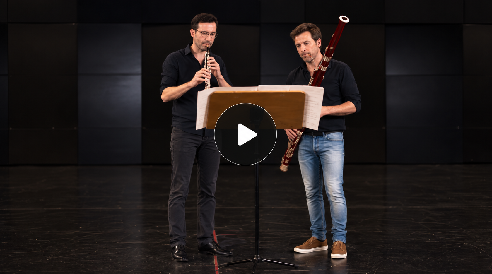 Two bassoonists rehearsing together on stage