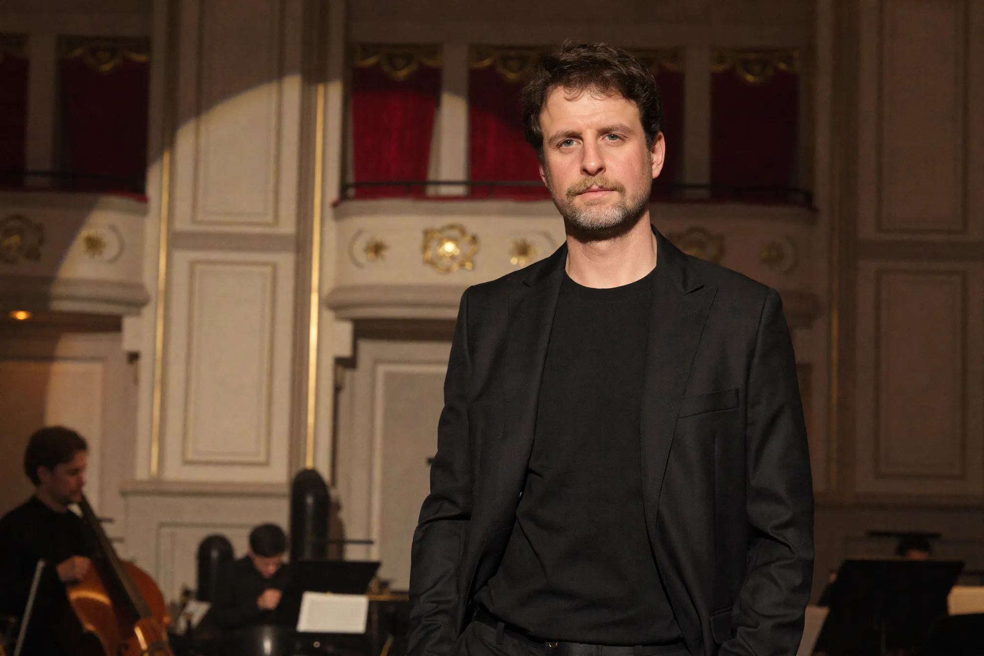 Moritz Winker in front of an opera-house auditorium
