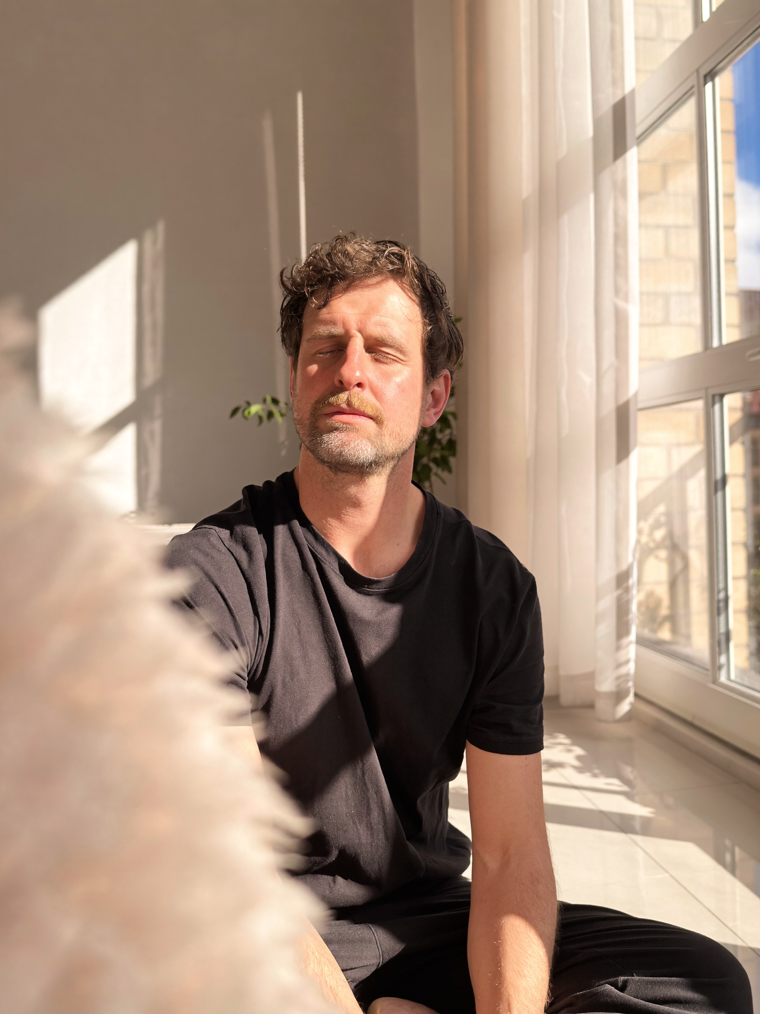 Moritz Winker seated beside a sunlit window